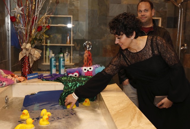 Make-A-Wish Southern Nevada CEO Caroline Ciocca places a rubber duck in the newly installed bathtub at the Gardner family home, Thursday, Jan. 12, 2017, in Las Vegas. Make-A-Wish Southern Nevada a ...