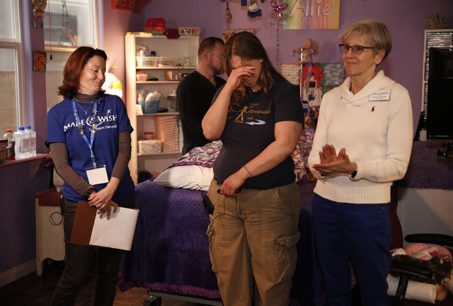 Sandy Gardner, center, is brought to tears after Make-A-Wish Southern Nevada and its partners formally revealed the Gardner family's long-awaited bathroom makeover, including a custom tub, at the ...