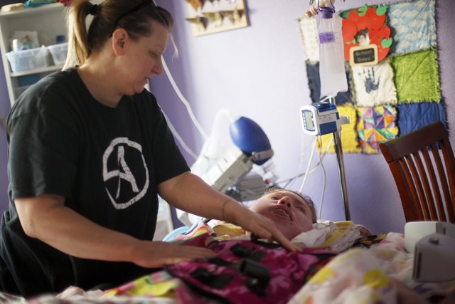 Sandy Gardner adjusts the clothes of Allison "Allie" Gardner in their home on Tuesday, Jan. 10, 2017. Allie has spinal muscular atrophy. (Rachel Aston/Las Vegas Review-Journal) @rookie__rae