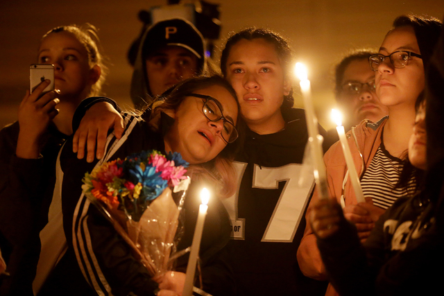 Bianey Castillo is consoled by Mara Moya, 17, at a vigil to honor Richard Nelson on Sunday, Jan. 15, 2017, at Chaparral High School in Las Vegas. Nelson was shot and killed Saturday night in front ...