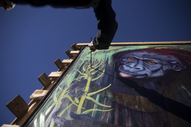 Local artist Kim Johnson paints a monkey to symbolize the past during the Chinese New Year in the Desert event at the Container Park on Saturday, Jan. 28, 2017, in Las Vegas. Erik Verduzco/Las Veg ...