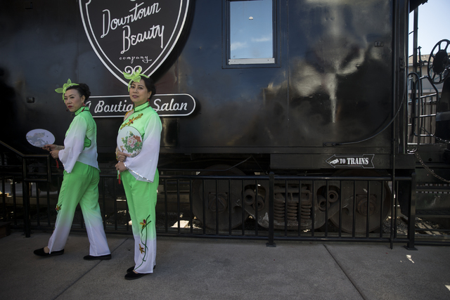 Suying Chen, left, and Fang Zhao, members of the Las Vegas Chinese Center Dance Troop, get ready to take perform in the Chinese New Year in the Desert event at the Container Park on Saturday, Jan. ...