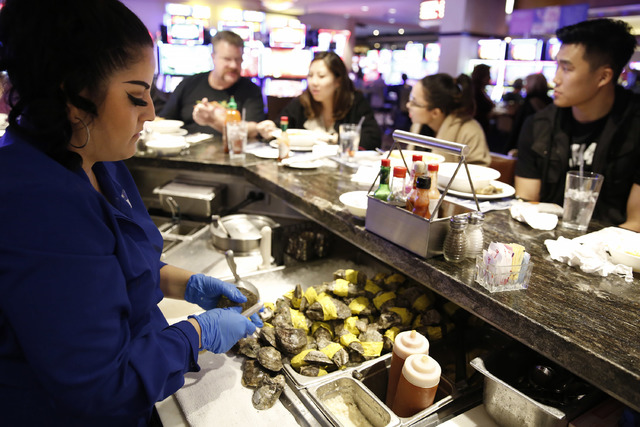 Server Brenda Guerrero shucks oysters at Oyster Bar at Palace Station hotel-casino on Saturday, Jan. 21, 2017, in Las Vegas. (David Guzman/Las Vegas Review-Journal) @DavidGuzman1985