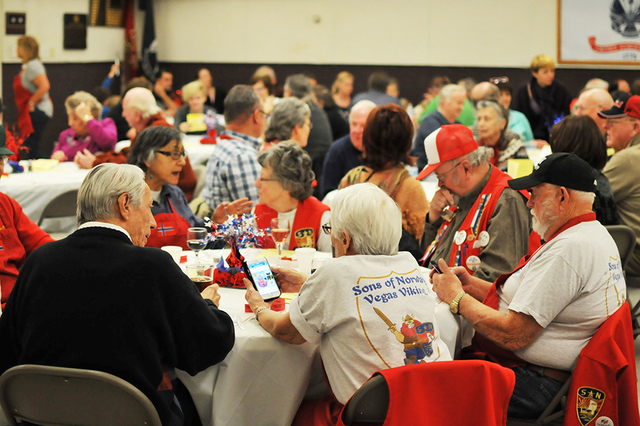 An attendee's Sons of Norway Vegas Viking T-shirt is seen in the foreground during the early lu ...