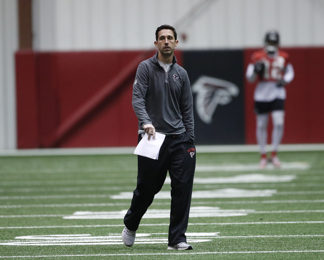 Atlanta Falcons offensive coordinator Kyle Shanahan walks on the field during an NFL football practice , Thursday, Jan. 19, 2017, in Flowery Branch, Ga.. TheFalcons will face the Green Bay Packers ...