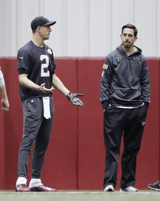 Atlanta Falcons quarterback Matt Ryan, left, stands on the field next to offensive coordinator Kyle Shanahan during a workout at the NFL football team's practice facility in Flowery Branch, Ga., F ...