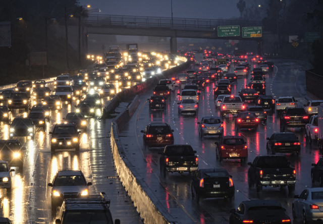 Early morning rush hour traffic crawls along the Hollywood Freeway on it's way toward downtown Los Angeles on Thursday, Jan. 12, 2017. Flooded roads and freeways along with low fog and clouds made ...