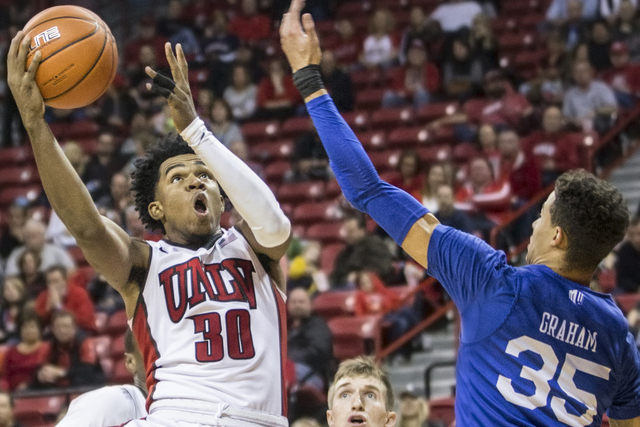 UNLV's Jovan Mooring (30) slashes to the basket over Air Force's Hayden Graham (35) during the Rebels home matchup with the Falcons on Saturday, Jan. 21, 2017, at the Thomas & Mack Center, in ...