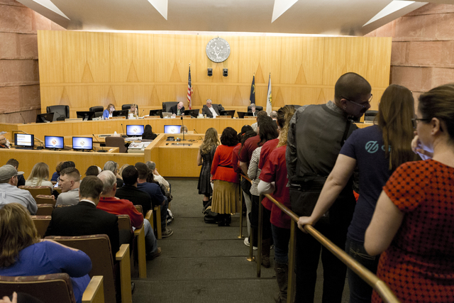 Dozens of individuals line up to give their testimony regarding the proposed development of 5,025 homes on Blue Diamond Hill to the County Commissioners Wednesday, Feb. 22, 2017, at the Clark Coun ...