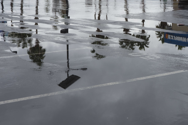 Puddles fill a parking lot on Saturday, Feb. 18, 2017, in downtown Las Vegas. On Friday a flash-flood watch for Southern Nevada that will last through Saturday evening was issued by weather servic ...