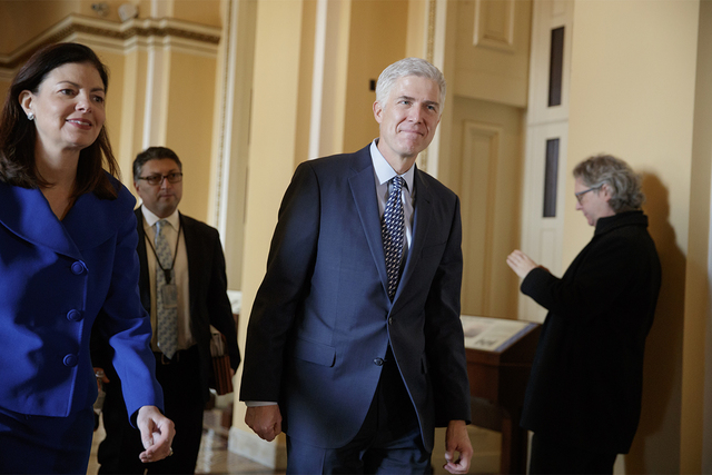Supreme Court Justice nominee Neil Gorsuch is escorted by former New Hampshire Sen. Kelly Ayotte on Capitol Hill in Washington, Feb. 2, 2017. (J. Scott Applewhite/AP)