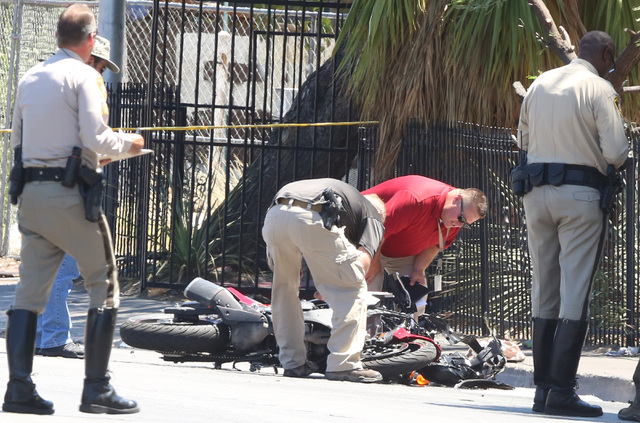 Las Vegas police investigate a crash involving a motorcycle near Twain Avenue and Swenson Street on July 19, 2016. A motorcyclist was taken to the hospital with potentially life-threatening injuri ...