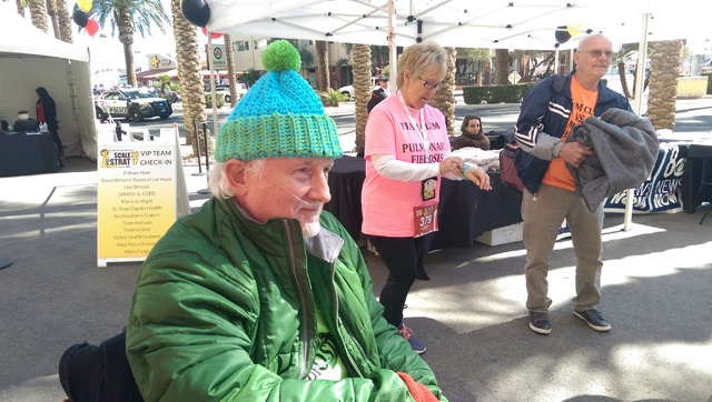 Clem Wiechecki watches his wife walk toward the Stratosphere tower as she prepares to climb the 1,455 steps to the top. (Brooke Wanser/Las Vegas Review-Journal)