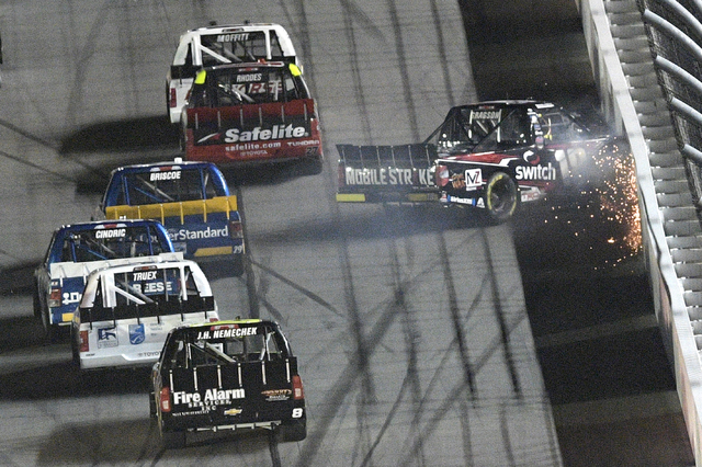 Noah Gragson (18) hits the wall along the front stretch, setting off a multi-car wreck going into Turn 1, during the NASCAR Trucks auto race at Daytona International Speedway, Friday, Feb. 24, 201 ...