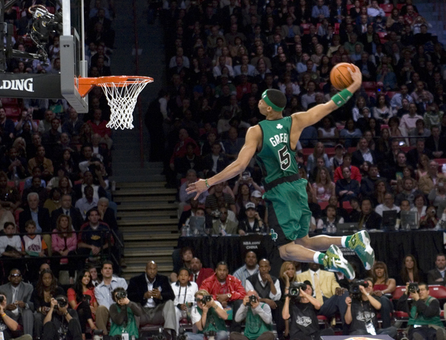 Gerald Green of the Boston Celtics flies over a table on his final dunk to win the Slam-dunk competition during NBA All-Star festivities at the Thomas & Mack Center Saturday, Feb. 17, 2007. (K ...