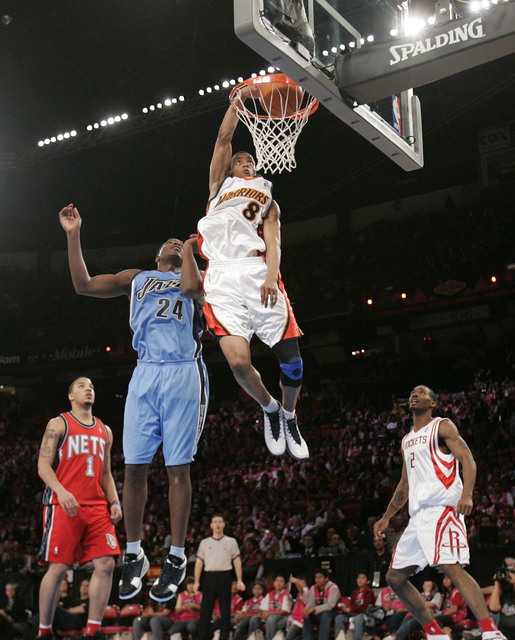 Monta Ellis of the Sophomore team makes a dunk over Paul Millsap of the Rookie team in the NBA All-Star Rookie Challenge basketball game at the Thomas & Mack Center in Las Vegas Saturday, Feb. ...