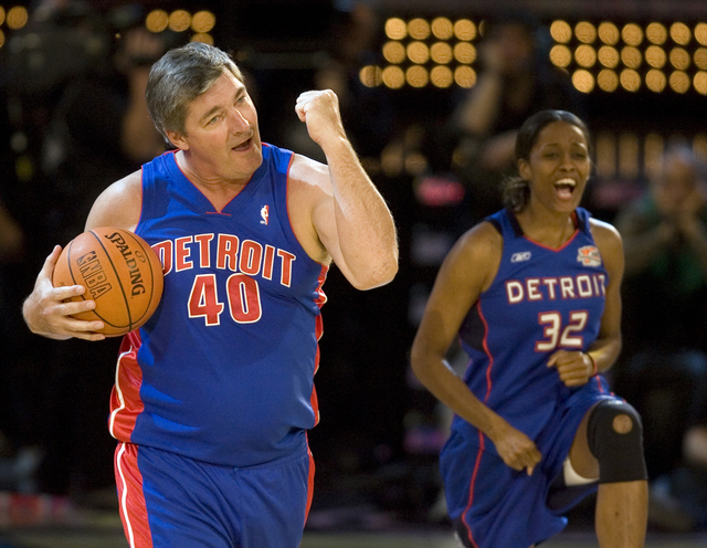 NBA legend Bill Laimbeer, left, and Swin Cash of the WNBA celebrate their teammate, current NBA player Chauncey Billups, sinking a half court shot in the Shooting Stars competition during NBA All- ...