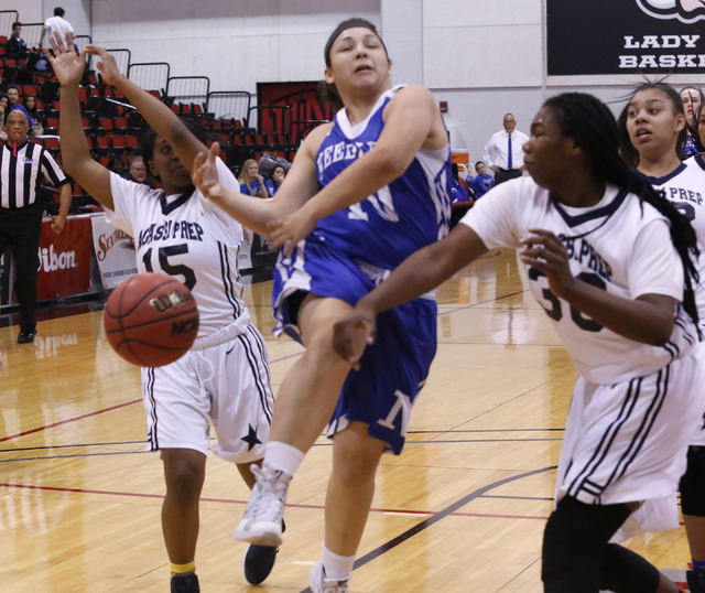 Agassi Prep's Sharmayne Finley (30) slaps the ball from the hands of Needle's Brenna Chavez (10) during the first half of a Class 2A girls state final championship game at the Cox Pavilion on Satu ...