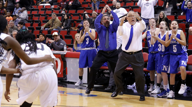 Needle's head coach Manuel Calderon call a time out as his player cheer during the second half of a Class 2A girls state final championship game at the Cox Pavilion on Saturday, Feb. 25, 2017, in ...