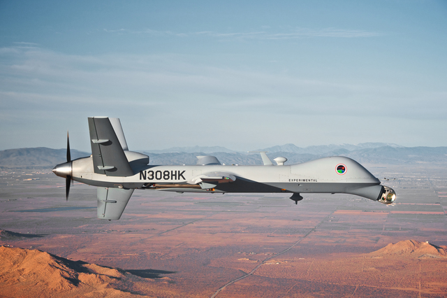 A remotely piloted MQ-9 Reaper fitted with a special targeting turret on its nose flies over White Sands Missile Range, New Mexico during tests in the summer of 2016 to develop a directed-energy l ...