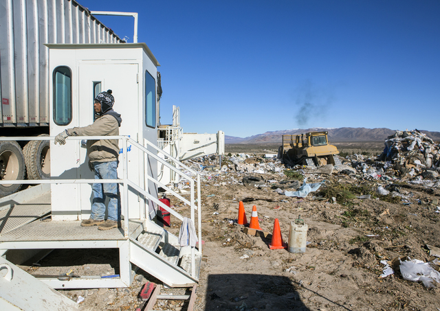 A worker watches a garbage hauler back in to dump at the Western Elite Ranch near U.S. 93 Highway about 60 miles north of Las Vegas on Wednesday, Jan. 25, 2017. (Jeff Scheid/Las Vegas Review-Journ ...
