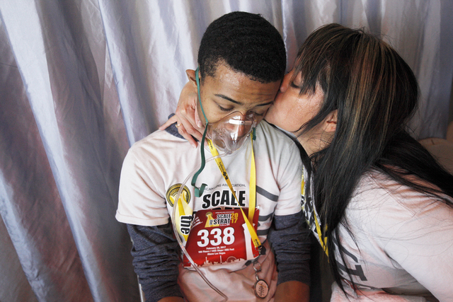 Heidi Avila kisses her son Christion Johnson after they both finished the Scale the Strat stair climb that raises money for the American Lung Association on Sunday, Feb. 26, 2017, at the Stratosph ...