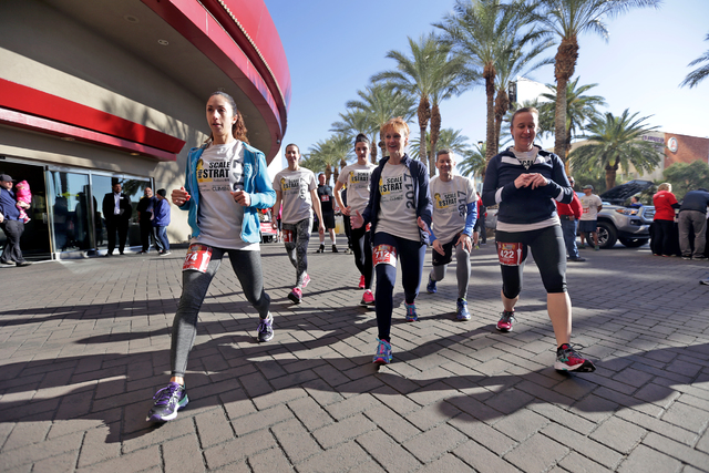 Denise Taylor, from left, Julie Usdavin, Crystal Haag, Christine Wagner, David Haddow and Priscilla Mau warm up before the Scale the Strat stair climb that raises money for the American Lung Assoc ...