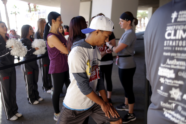 Christion Johnson stretches he waits to participate in the Scale the Strat stair climb that raises money for the American Lung Association on Sunday, Feb. 26, 2017, at the Stratosphere in Las Vega ...