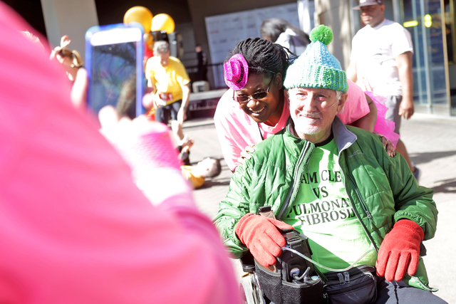 Debbie Wiechecki takes a photo of her husband Clem Wiechecki and their friend Ina-Robin Williams at the Scale the Strat stair climb that raises money for the American Lung Association on Sunday, ...