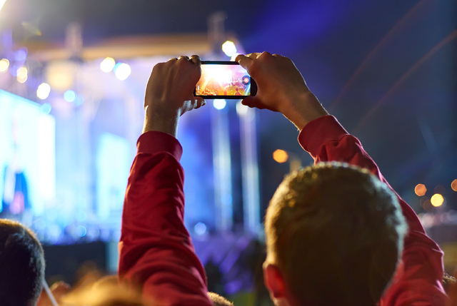 Recording video with smartphone during a concert. (Thinkstock)