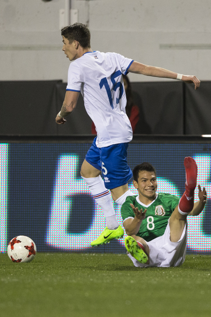 Mexicoճ Hirving Lozano (8) loses a shoe during a play against Iceland in the men's soccer exhibition match at Sam Boyd Stadium on Wednesday, Feb. 8, 2017, in Las Vegas. Mexico won 1-0. (Erik ...