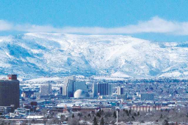 The snow-covered foothills of the Sierra's eastern front are seen beyond the Reno skyline, Feb. 1, 2016. (Scott Sonner/AP)