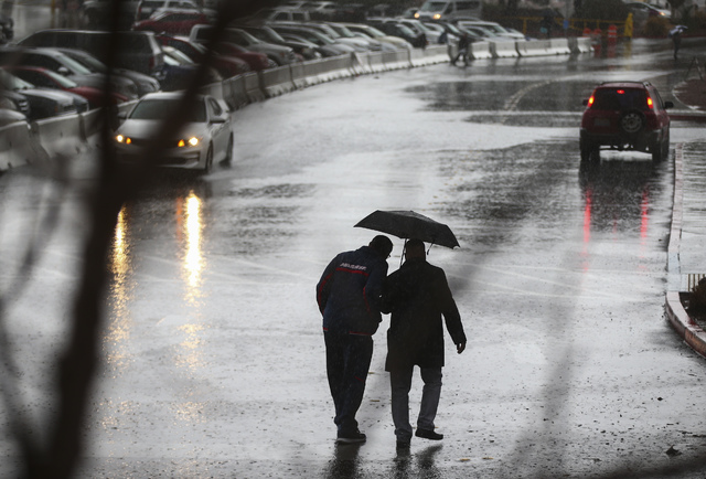 People navigate heavy rain at UNLV in Las Vegas on Saturday, Feb. 18, 2017. (Chase Stevens/Las Vegas Review-Journal) @csstevensphoto