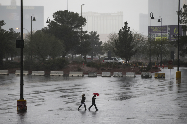People walk as rain pours down at UNLV in Las Vegas on Saturday, Feb. 18, 2017. (Chase Stevens/Las Vegas Review-Journal) @csstevensphoto