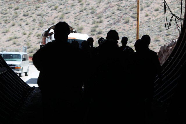 Congressional staff members, media and Department of Energy employees exit the north portal during a congressional tour of the Yucca Mountain exploratory tunnel Thursday, April 9, 2015. (Sam Morri ...