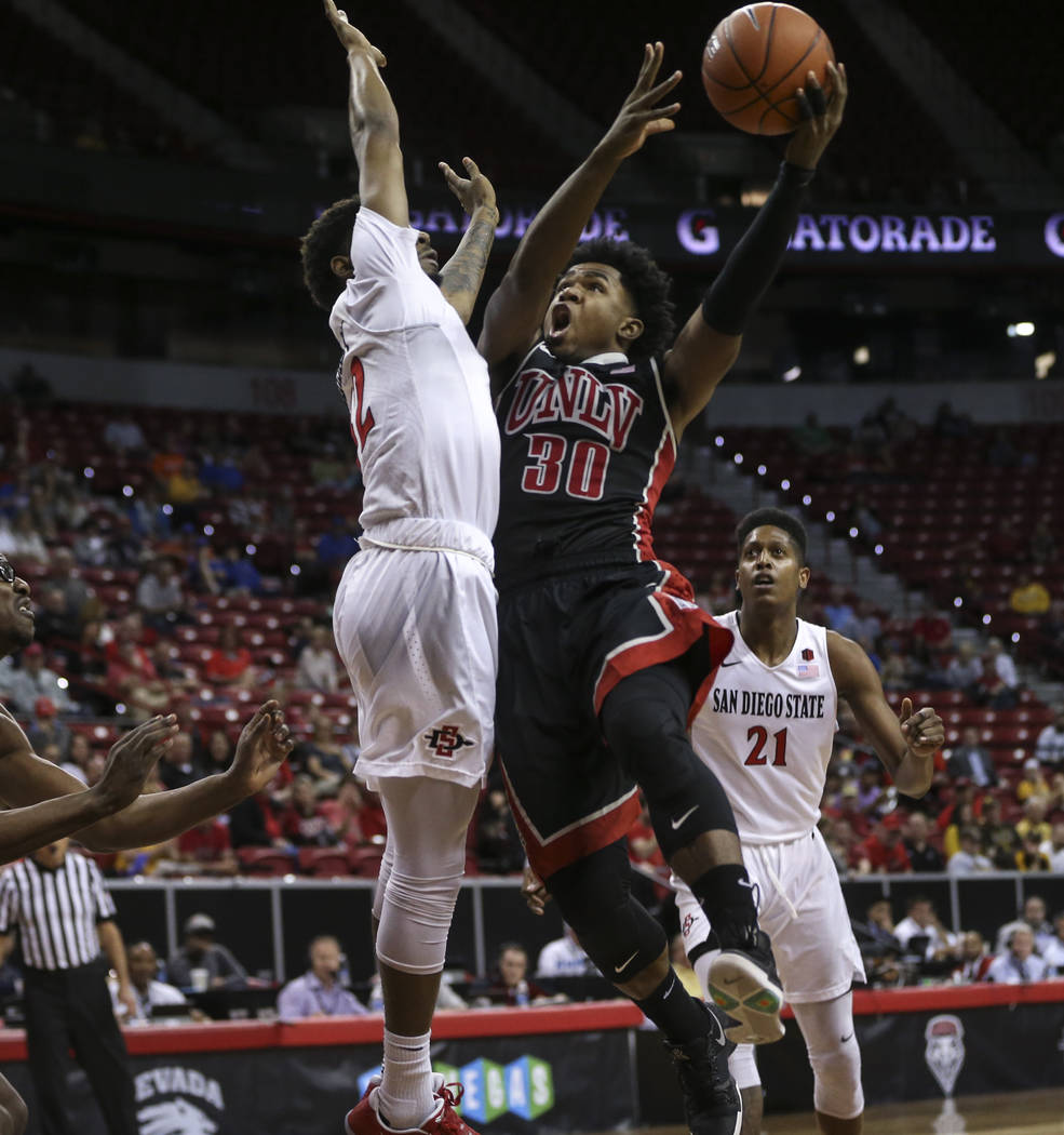 UNLV guard Jovan Mooring (30) shoots against San Diego State guard Jeremy Hemsley (42) during a Mountain West Conference tournament basketball game at the Thomas & Mack Center in Las Vegas on  ...