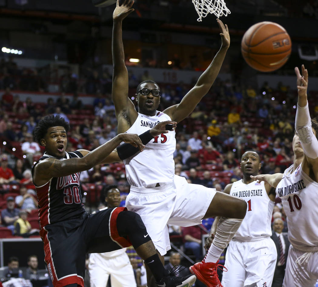 UNLV guard Jovan Mooring (30) throws a pass as San Diego State center Valentine Izundu (45) defends during a Mountain West Conference tournament basketball game at the Thomas & Mack Center in  ...