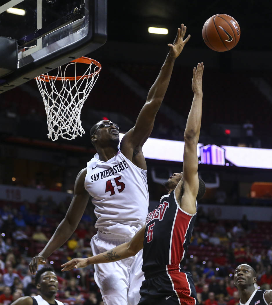 San Diego State center Valentine Izundu (45) blocks a shot from UNLV guard Jalen Poyser (5) during a Mountain West Conference tournament basketball game at the Thomas & Mack Center in Las Vega ...