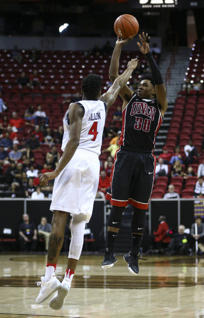 UNLV guard Jovan Mooring (30) shoots over San Diego State guard Dakarai Allen (4) during a Mountain West Conference tournament basketball game at the Thomas & Mack Center in Las Vegas on Wedne ...