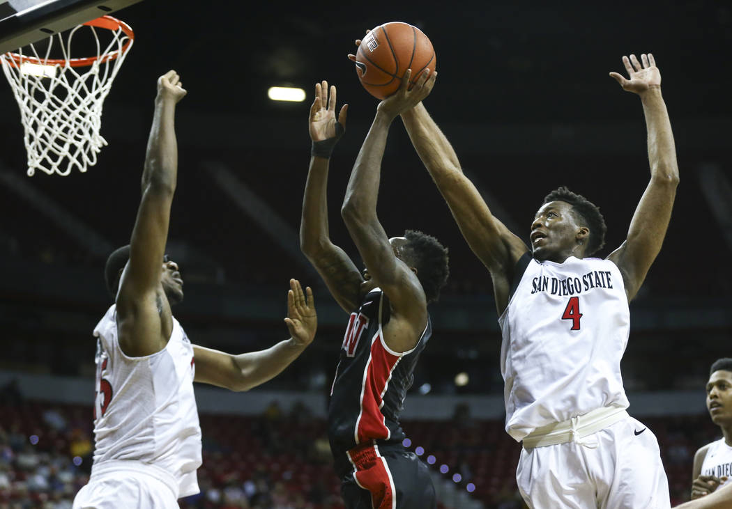 San Diego State guard Dakarai Allen (4) looks to block a shot from UNLV guard Kris Clyburn (1) during a Mountain West Conference tournament basketball game at the Thomas & Mack Center in Las V ...