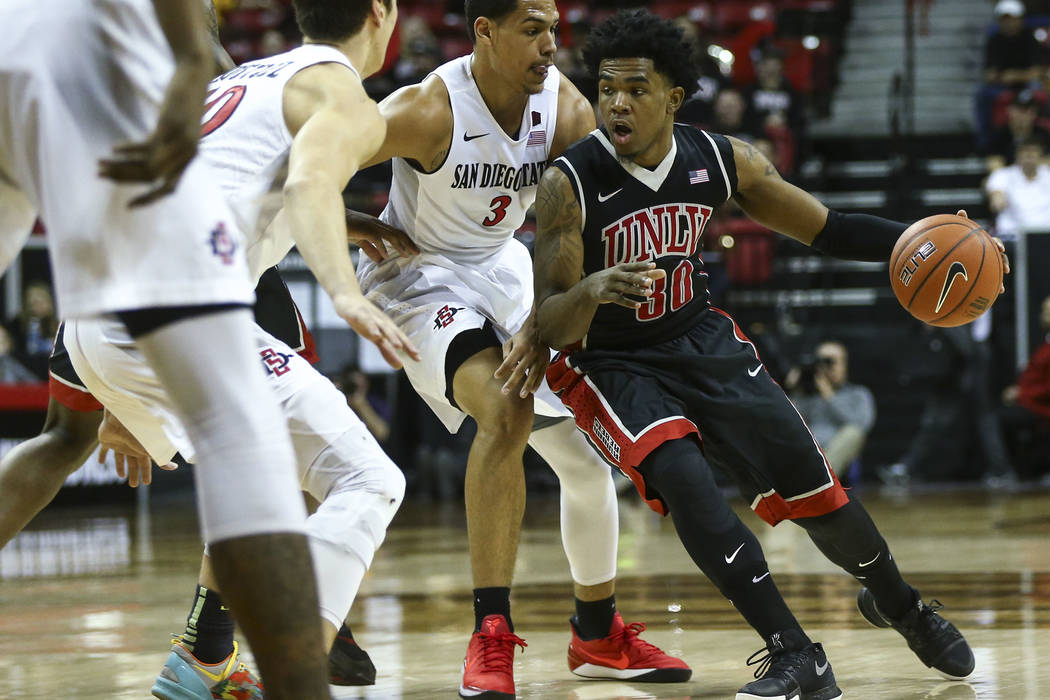 UNLV guard Jovan Mooring (30) drives to the basket against San Diego State guard Trey Kell (3) during a Mountain West Conference tournament basketball game at the Thomas & Mack Center in Las V ...