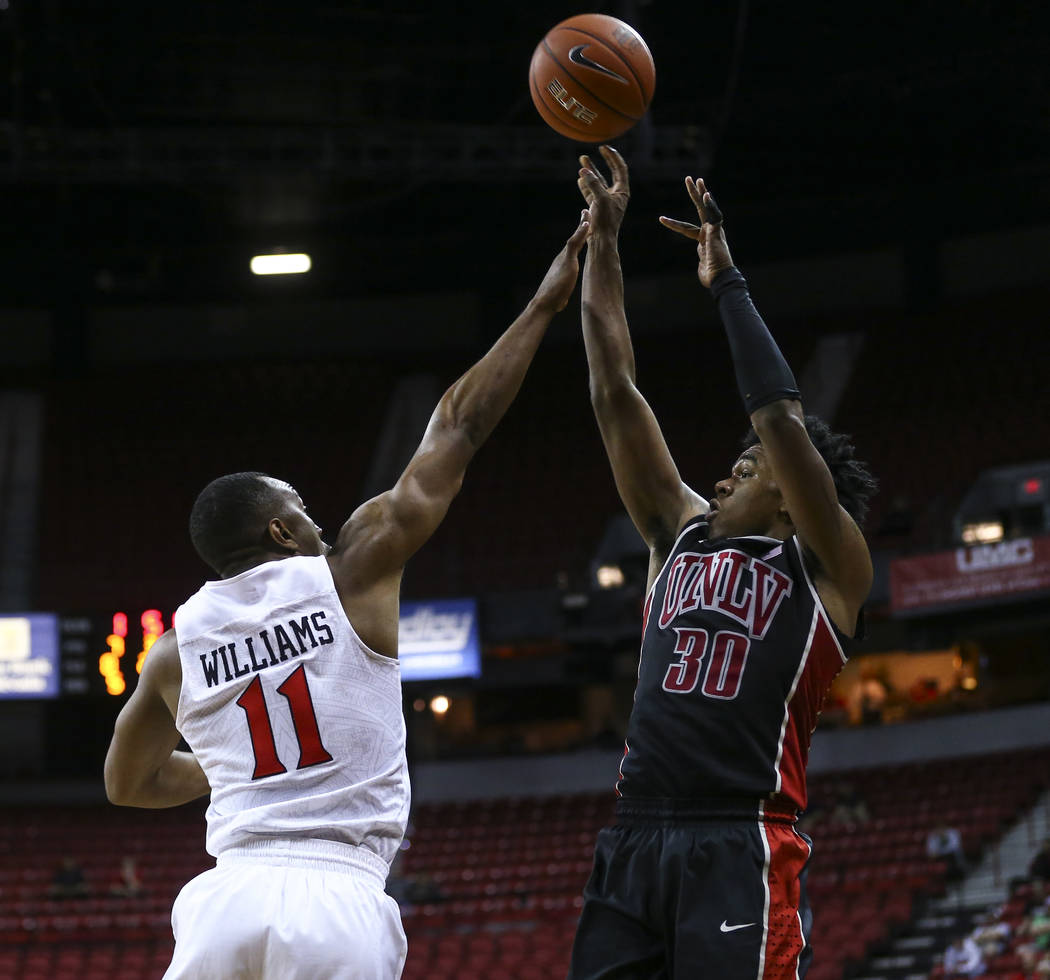 UNLV guard Jovan Mooring (30) shoots over San Diego State guard D'Erryl Williams (11) during a Mountain West Conference tournament basketball game at the Thomas & Mack Center in Las Vegas on W ...
