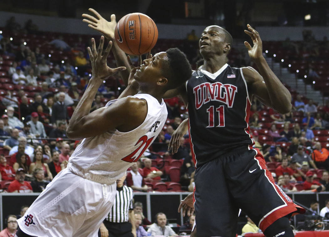San Diego State forward Malik Pope (21) and UNLV forward Cheickna Dembele (11) fight for a rebound during a Mountain West Conference basketball game at the Thomas & Mack Center in Las Vegas on ...