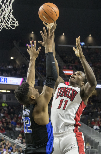 UNLV's Uche Ofoegbu (11) shoots over Duke's Javin DeLaurier (12) during the Rebels home matchup with the Blue Devils at T-Mobile Arena on Saturday, Dec. 10, 2016, in Las Vegas. Benjamin Hager/Las ...