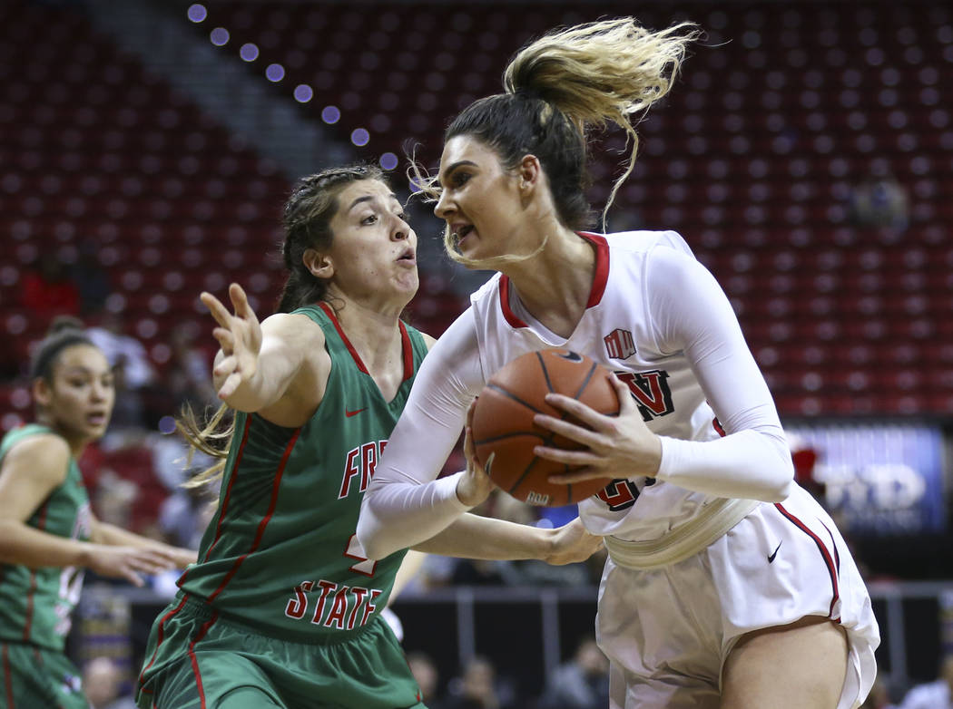 UNLV center Katie Powell (21) drives to the basket against Fresno State center Bego Faz Davalos (4) during the Mountain West Conference basketball tournament at the Thomas & Mack Center in Las ...