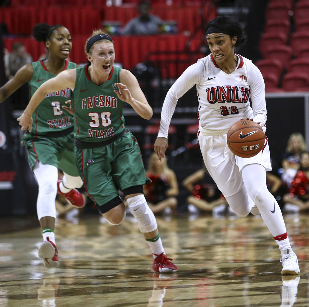 UNLV guard Dylan Gonzalez (11) drives against Fresno State forward Kristina Cavey (30) during the Mountain West Conference basketball tournament at the Thomas & Mack Center in Las Vegas on Wed ...