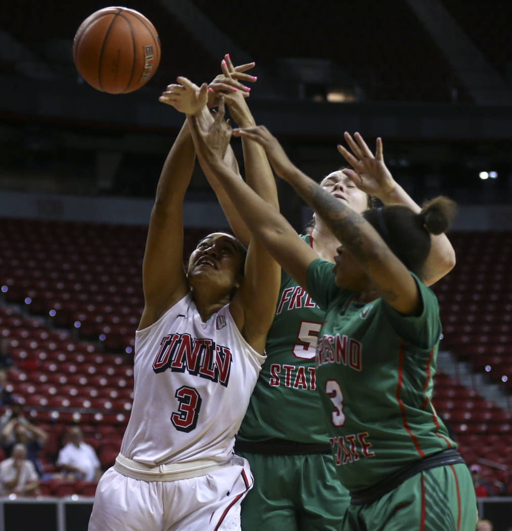 UNLV forward Paris Strawther (3) fights for a rebound against Fresno State center Katelin Noyer (5) and guard Tory Jacobs (3) during the Mountain West Conference basketball tournament at the Thoma ...