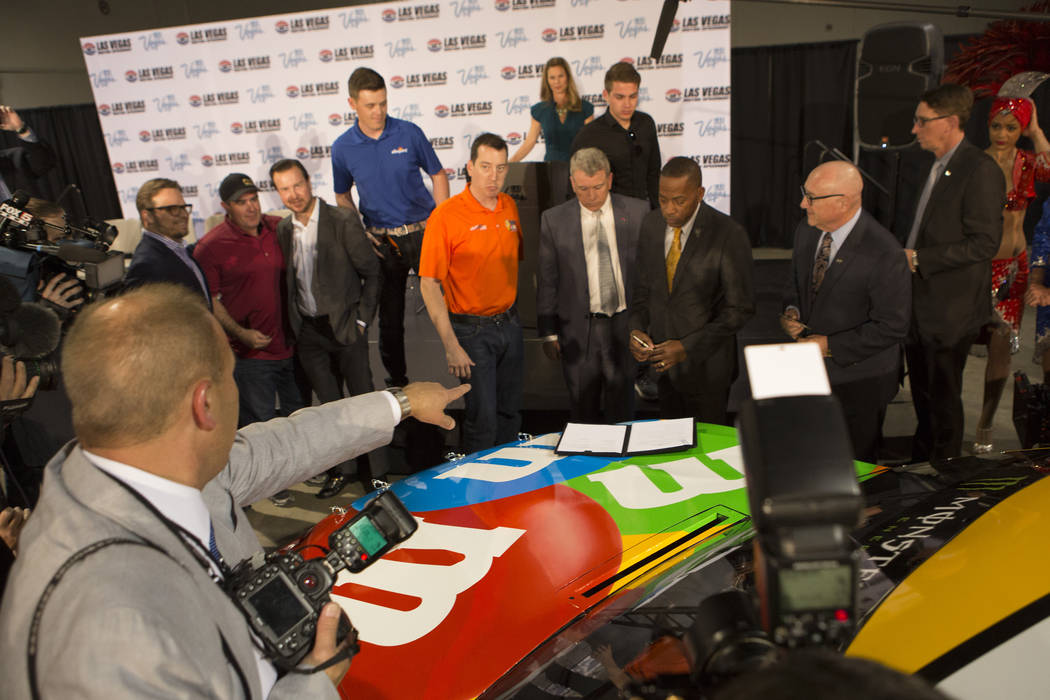 Individuals prepare for a photo opportunity at Cashman Center on Wednesday, March 8, 2017, in Las Vegas. It was announced that Las Vegas Motor Speedway will host a second NSCAR race in the fall st ...