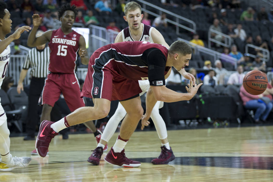 Stanford Cardinal forward Reid Travis (22) makes a pass as he stumbled against Arizona State Sun Devils in the Pac-12 Men's Basketball Tournament game at T-Mobile Arena on Wednesday, March 8, 2017 ...