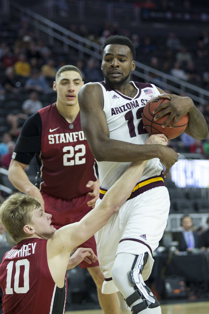 Stanford Cardinal forward Michael Humphrey (10) attempts to steal the ball from the floor against Arizona State Sun Devils forward Andre Adams (12) in the Pac-12 Men's Basketball Tournament game a ...